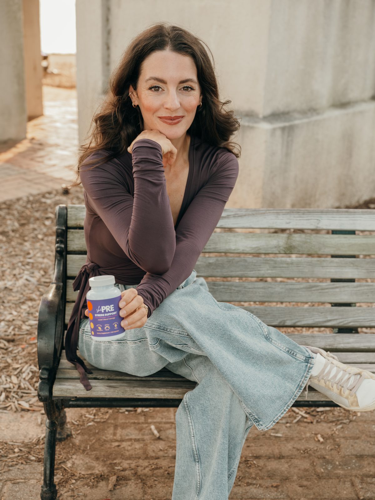 Lyndsay, shePRE founder, holding a bottle of shePRE