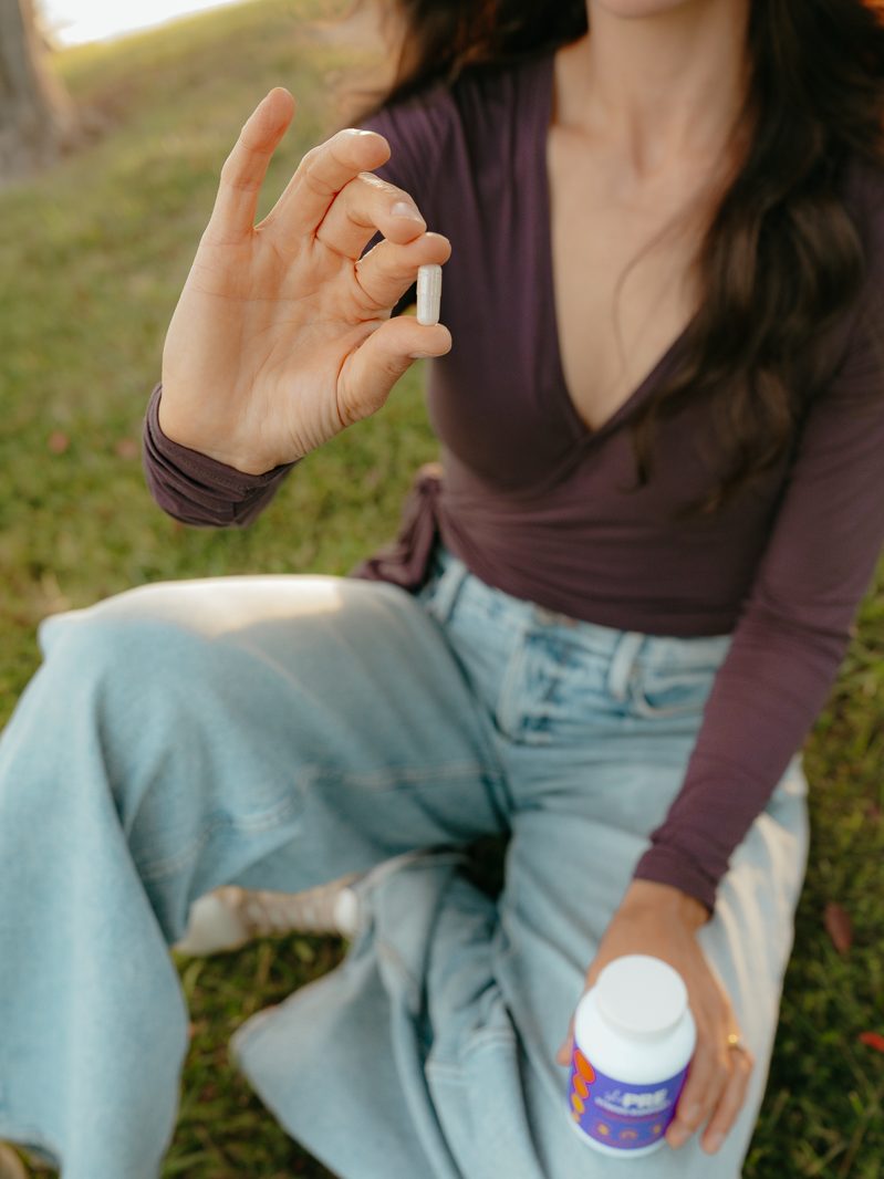 Lyndsay holding up a shePRE capsule